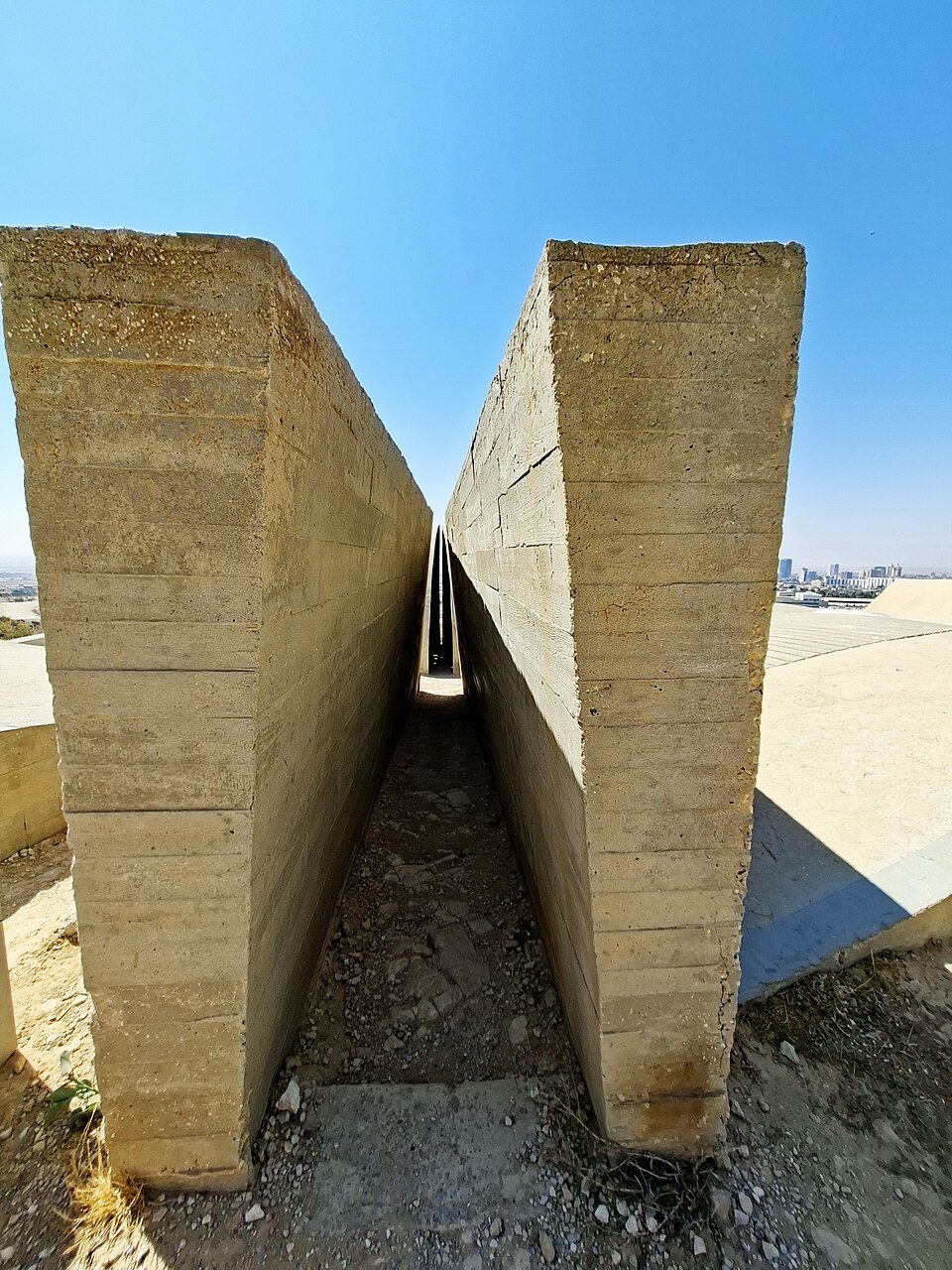 מעבר צר בין קירות בטון באנדרטת הנגב בבאר שבע
